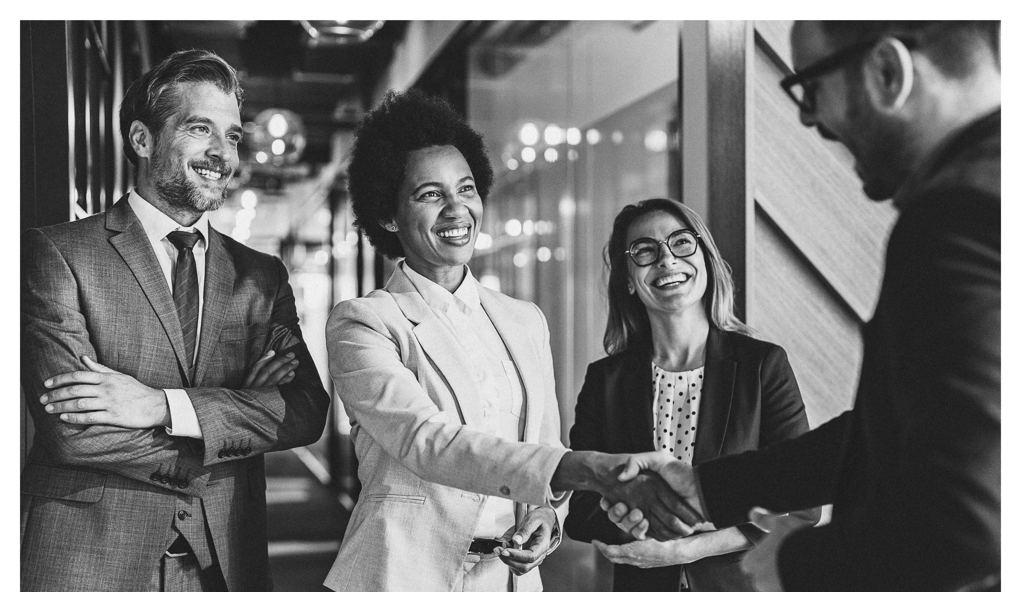 Group of business persons shaking hands in the office